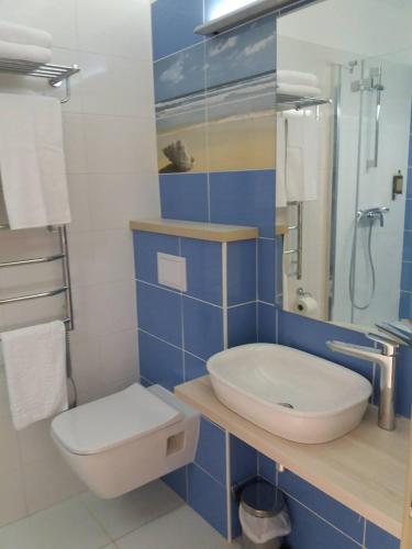 a bathroom with a sink and a toilet in it at Villa RK DeLuxe in Zatoka