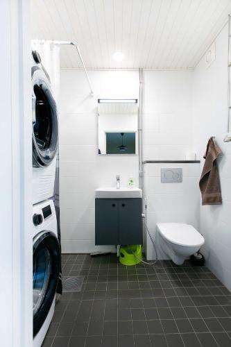 a bathroom with a washing machine and a sink at Design Apartments Kristiina in Naantali