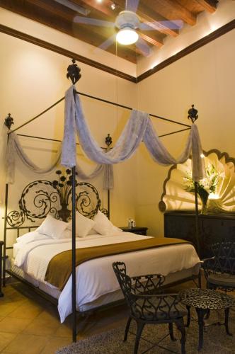 a bedroom with a large bed with a canopy at Casalinda San Miguel in San Miguel de Allende