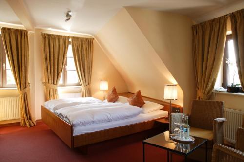 a bedroom with a bed in a room with windows at Landhaus Wolf - wir freuen uns in Schwäbisch Hall