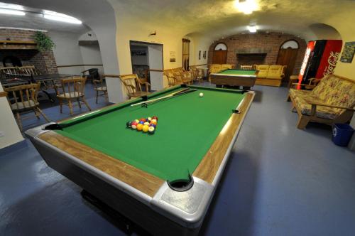 a room with a pool table in a room at Hotel Tadoussac in Tadoussac