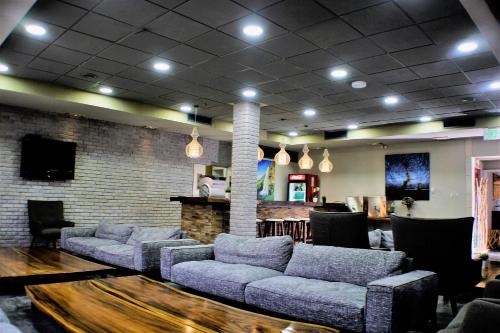 a living room with couches and a bar at Yarden Estate Hotel in Yesod Hamaala