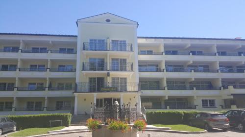 a large white building with a balcony in front of it at Appartementhaus Wimmerhof in Bad Füssing