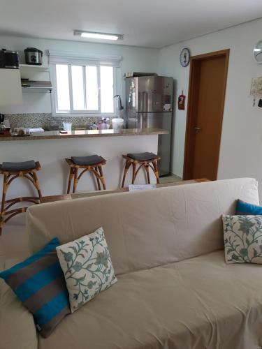 a living room with a couch and a kitchen at Linda Casa em Juquehy in Juquei