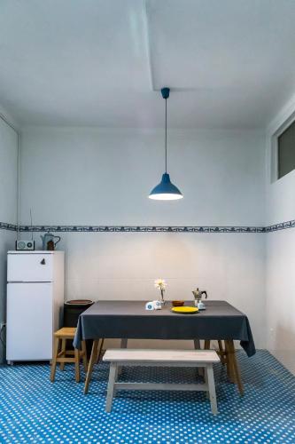 a dining room with a table and a refrigerator at Downtown Shelter - Casa da Praça in Aveiro
