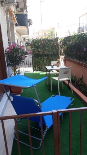a balcony with two tables and a table and chairs at Holiday House Marlin in Giardini Naxos
