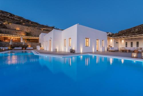 a villa with a swimming pool at night at Sotavento Villa in Fanari