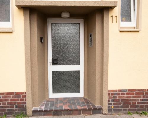 a front door of a house with a brick stoop at AVR Apartment Geestemunde in Bremerhaven