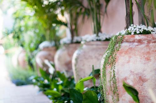 a row of concrete pots with plants in them at Hotel Bel-Air - Dorchester Collection in Los Angeles