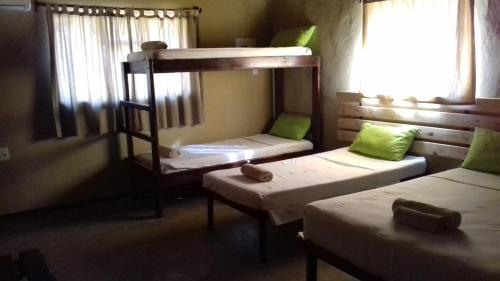 a room with two bunk beds and a window at Phokoje Bush Lodge in Selebi-Pikwe