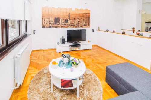 a living room with a couch and a table at LUXURY 3 story House- BEST VIEW in Sarajevo