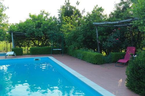 a swimming pool in a yard with a table and chairs at Desiderio D'Ammore in Corbara