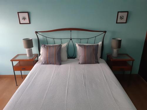 a bedroom with a large bed with two night stands at Dulce Vita Apartment in Praia