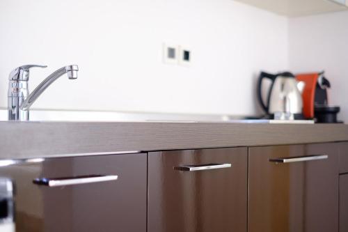 a kitchen with a sink and a counter top at Gerakari Suites in Agia Pelagia