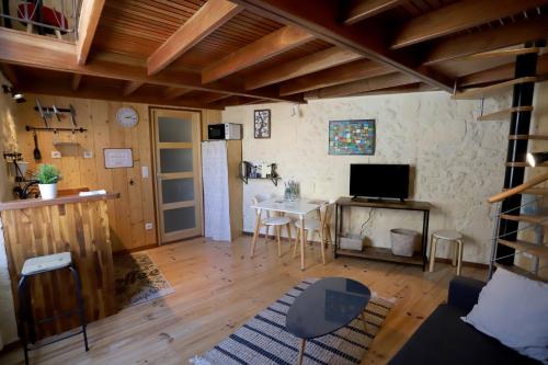 a living room with a table and a refrigerator at Les Appartements de la Victoire, Centre-ville, Possibilité Parking GRATUIT in Bordeaux