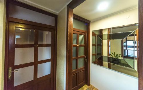 a hallway with a door and a mirror at Talismano Apartments in Smederevo