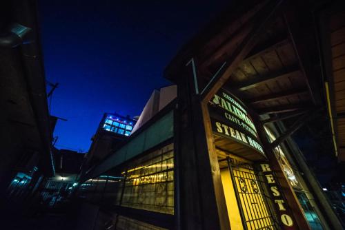 a building with a sign on the side of it at night at Talismano Apartments in Smederevo