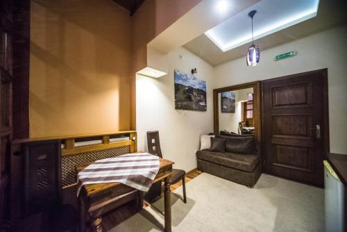 a room with a couch and a table and a door at Talismano Apartments in Smederevo