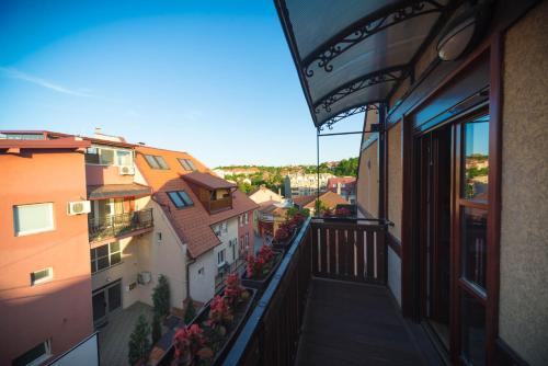 a balcony of a building with flowers on it at Talismano Apartments in Smederevo