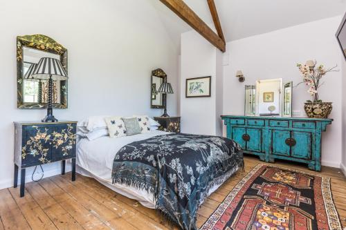 a bedroom with a bed and a blue dresser at The Delaval Rooms in Lincoln
