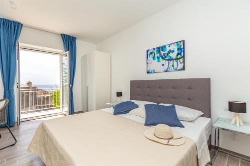 a bedroom with a large bed with a large window at Hedera Estate, Villa Hedera V in Dubrovnik