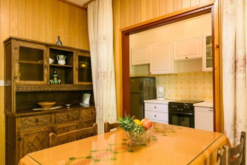 a kitchen with a table with a bowl of fruit on it at Trogir apartment Blaga in Trogir