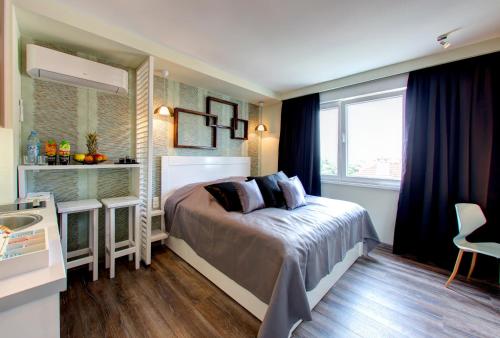 a small bedroom with a bed and a window at Luxury Studio Yasmine in Mostar