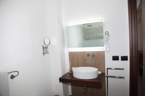 a bathroom with a sink and a mirror at Ermes B&B in Falcone