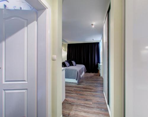 a hallway leading to a bedroom with a bed at Luxury Studio Yasmine in Mostar