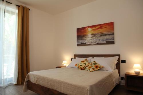 a bedroom with a bed with two pillows at Ermes B&B in Falcone