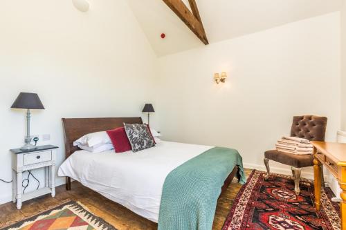 a bedroom with a bed and a desk and a chair at Tailor Room 2 in Lincoln