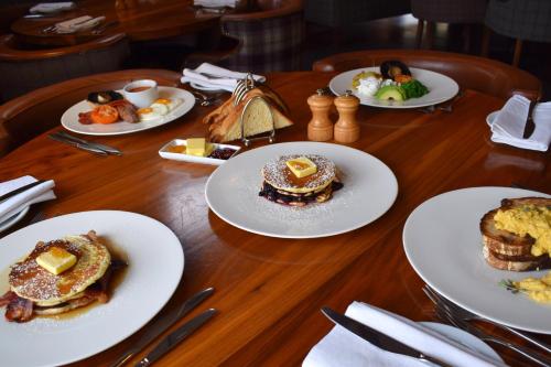 una mesa de madera con platos de comida. en Tailor Room 2 en Lincoln