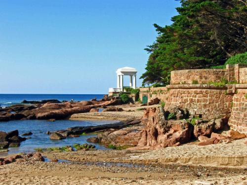 a lighthouse on the shore of a rocky beach at Camping les Acacias in Fréjus