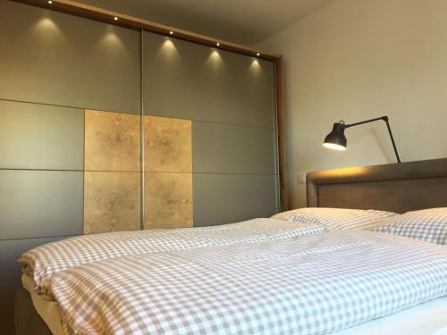 a bedroom with a bed with a checkered blanket at Weststrandperle in Norderney