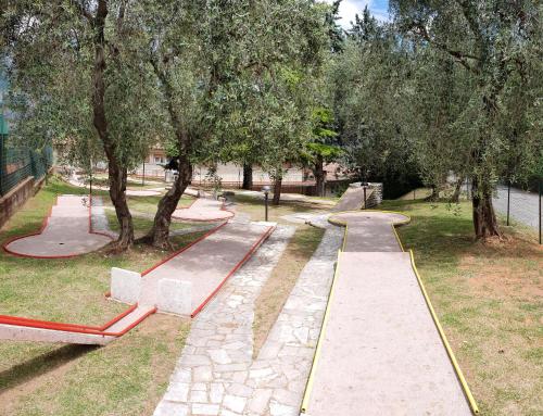 a skate park with a skateboard ramp and trees at Village Bazzanega - Montagnoli Group in Tremosine Sul Garda