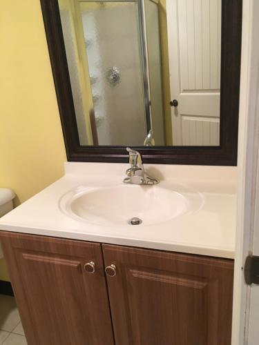 a bathroom with a sink and a mirror at Beach Fantasy Apartment Suites in Old Orchard Beach