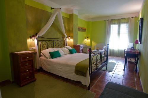 a bedroom with a bed with a canopy at Hotel Sierra Quilama in San Miguel de Valero