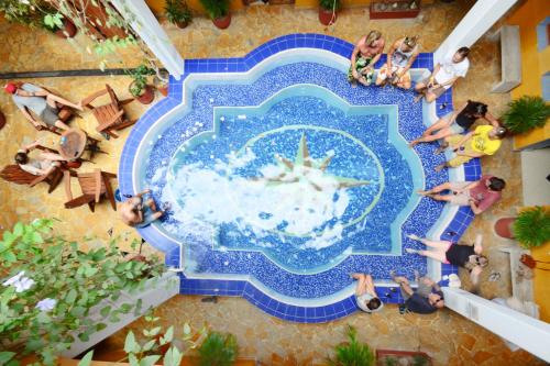 an overhead view of people in a pool at a resort at La Brisa Loca Hostel in Santa Marta