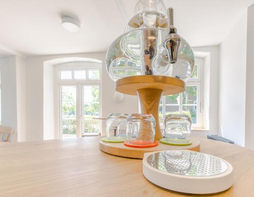 a dining room table with a glass chandelier at Hotel Johnsburg in Uelzen
