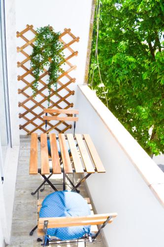 a porch with two benches and a table at Belém River Apartment II in Lisbon