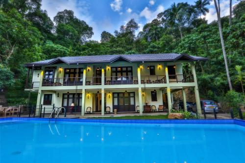 a house with a pool in front of it at Huluganga Ridge, Kandy in Kandy