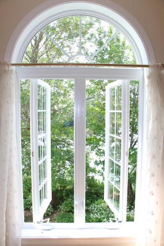 an open window with a view of the trees at La Maison Jaune D'Eastman in Eastman