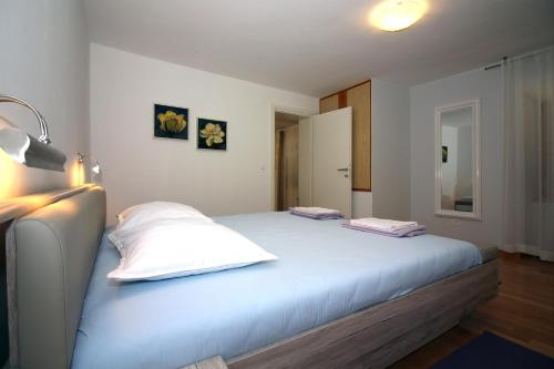 a bedroom with a bed with two pillows on it at Apartmani TEO in Tisno