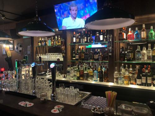 
a bar that has a lot of bottles on it at Hotel 55 - City Centre in Amsterdam
