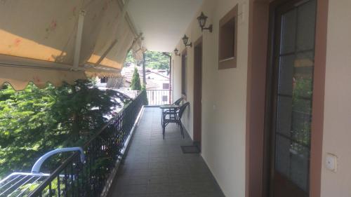 a balcony of a building with a chair on the side at Guesthouse Platon in Órma