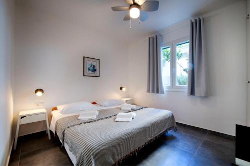 a bedroom with a bed with two towels on it at Apartmani Dule Komiza in Komiža