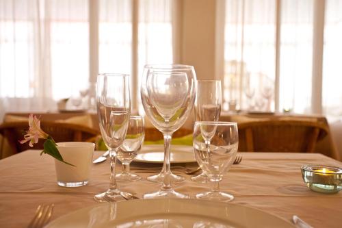 a table with wine glasses and a plate on it at Galaxia Boutique Hotel in Can Picafort