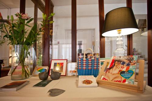 a table with a lamp and some items on it at Galaxia Boutique Hotel in Can Picafort