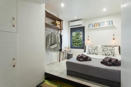 a bedroom with a bed in a room with white walls at Lazaristes Compact Living in Thessaloniki