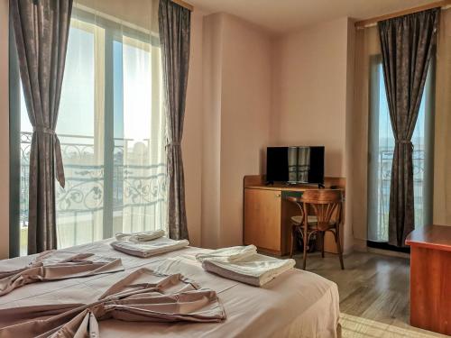 a hotel room with two beds and a window at Empera H-l in Sunny Beach
